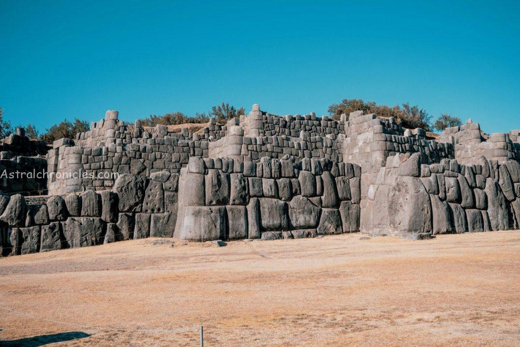 a large stone wall in the middle of a desert